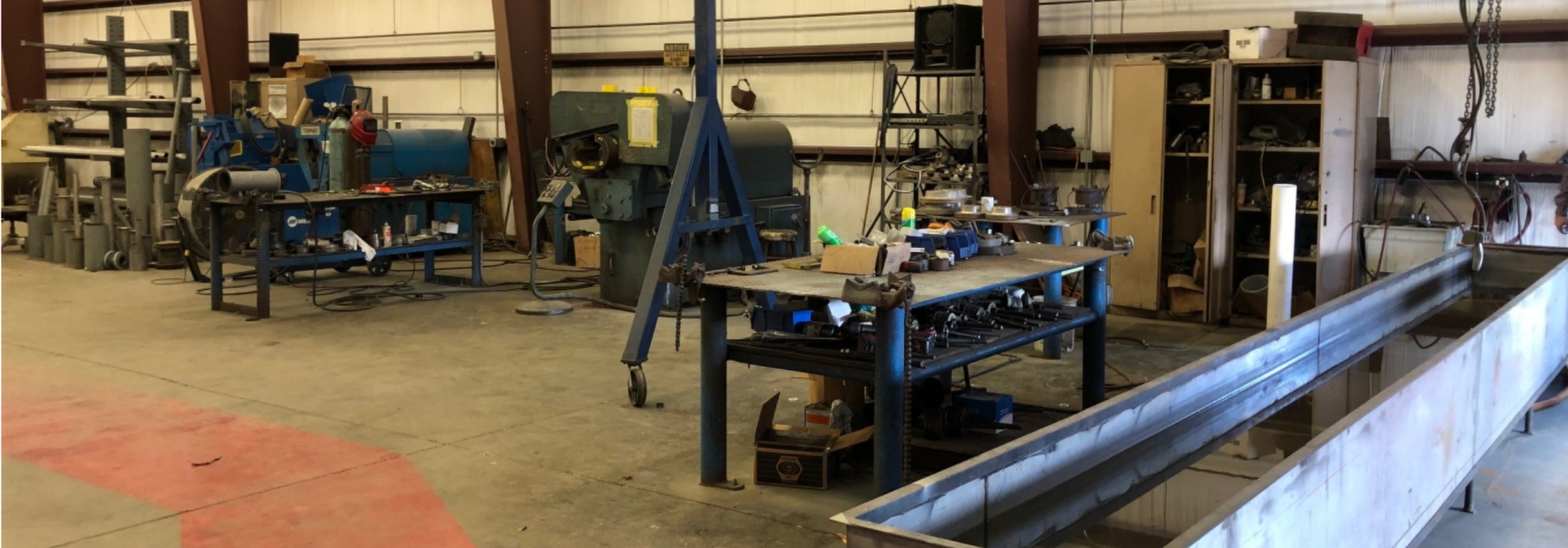 The Marspec fabrication shop in Fairhope: work benches, a jib crane and the hydrotest tank
